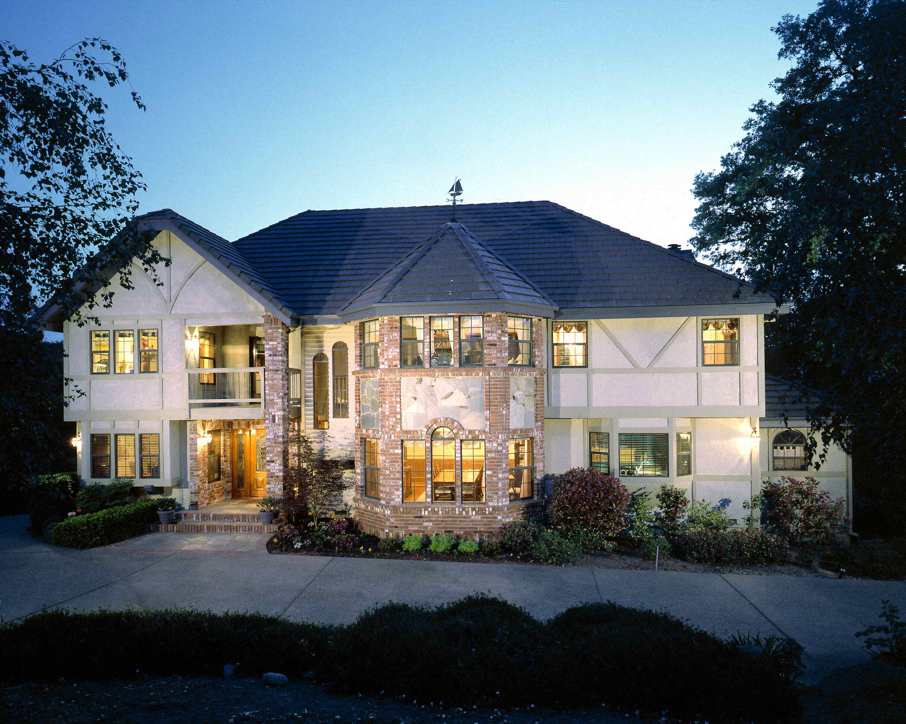Tudor-style Sacramento-area home with restored stucco and trim, photographed at dusk